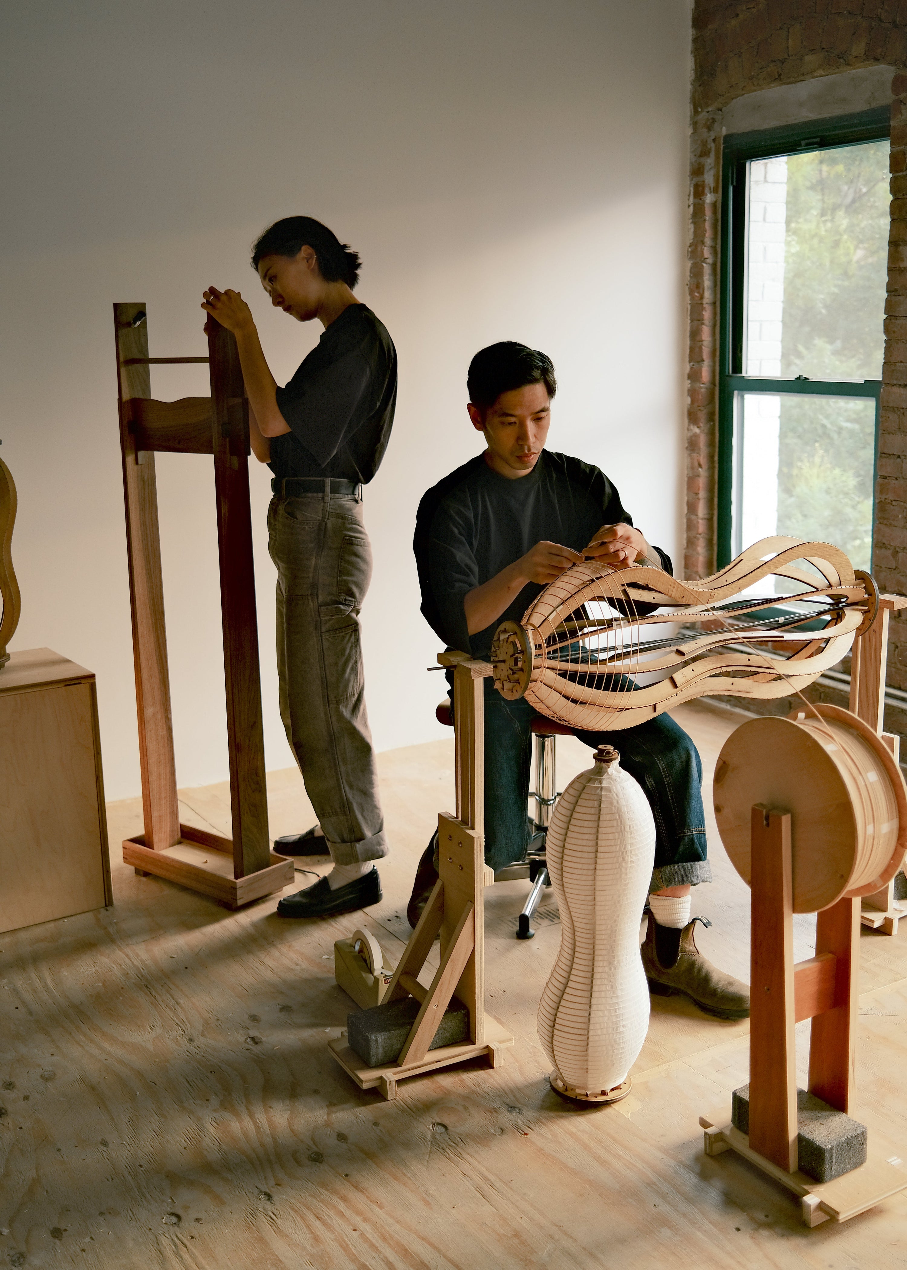Designer duo Irisa Kawabi and Aaron Kawabi showing their handcrafted paper lamp making process in their Brooklyn studio
