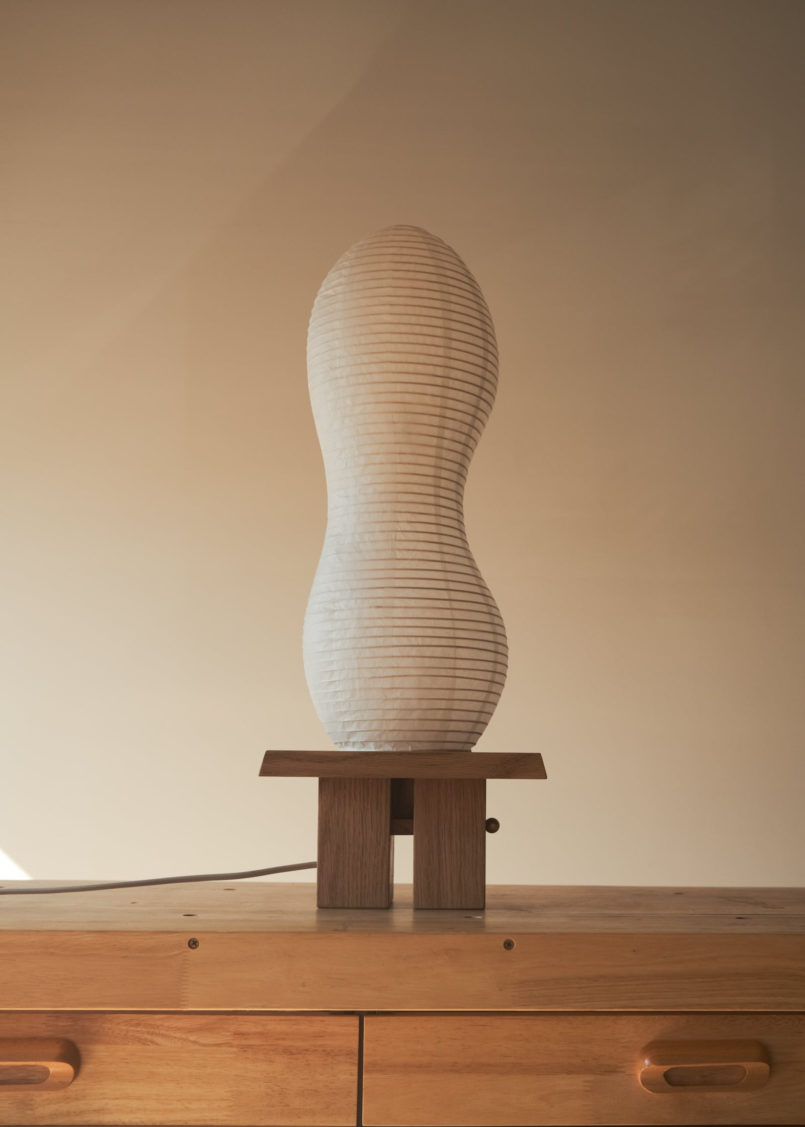 A straight-on shot of Kawabi's Legume Lamp made of Japanese washi and White Oak. 