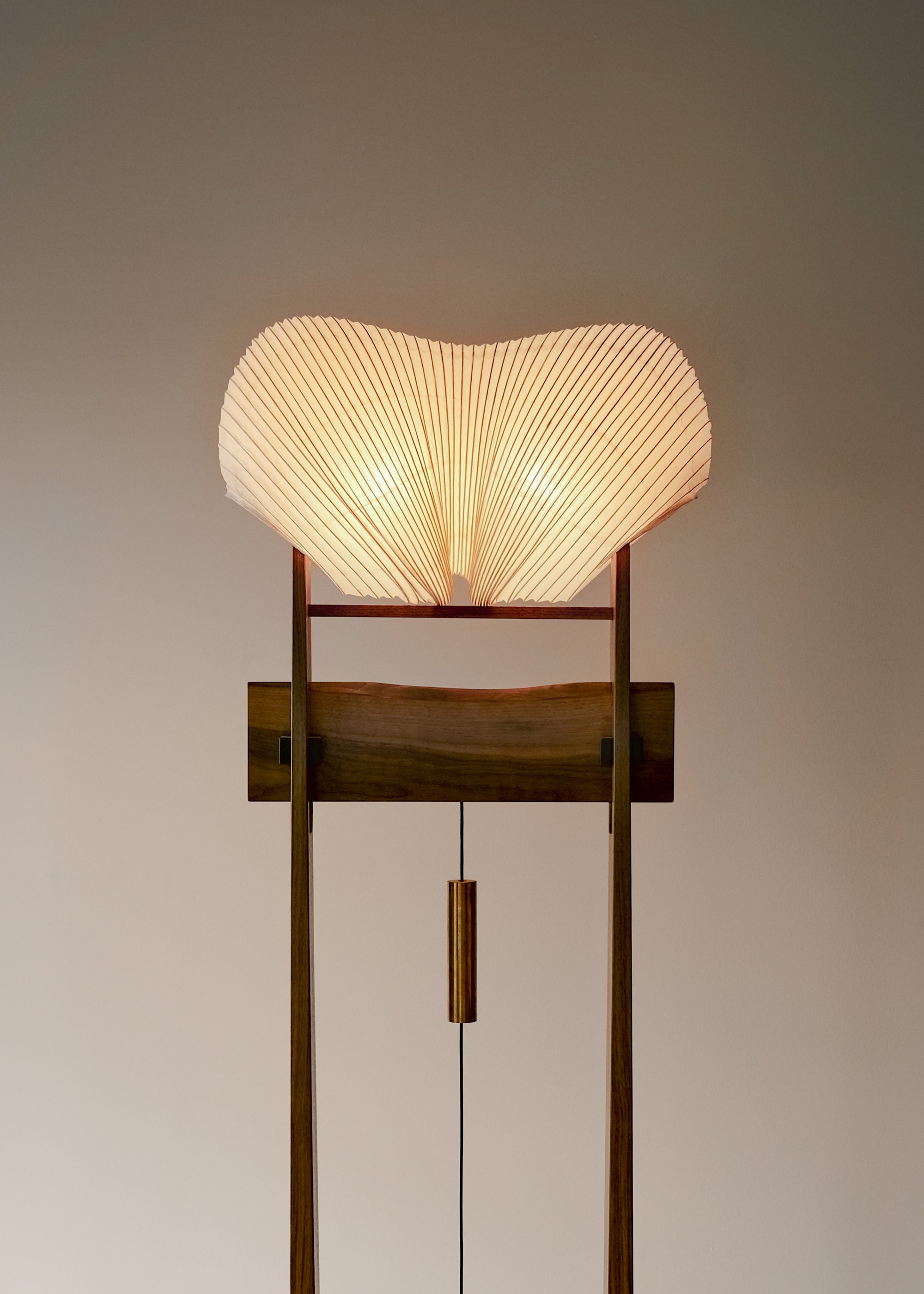 A close-up front view of Kawabi's Souvenir Floor Lamp lit up, focusing on the organic, undulating paper shade form.