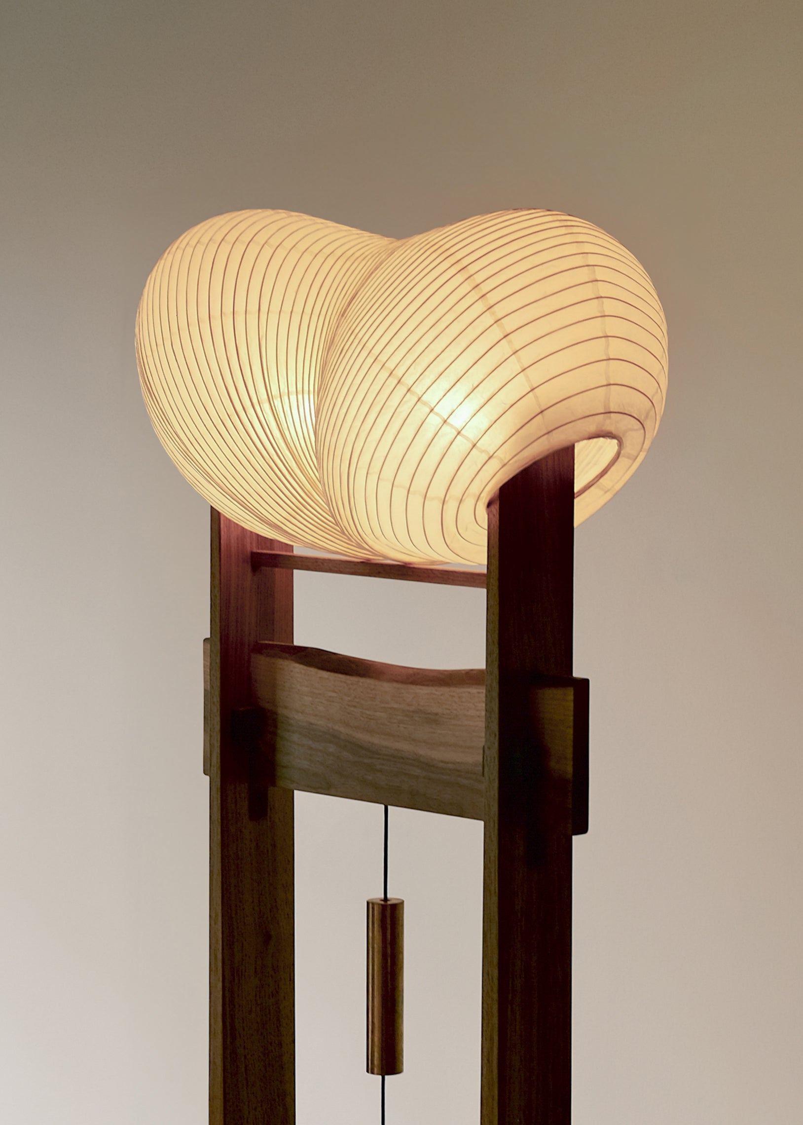 A close-up side view of Kawabi's Souvenir Floor Lamp lit up, focusing on the organic paper shade detail