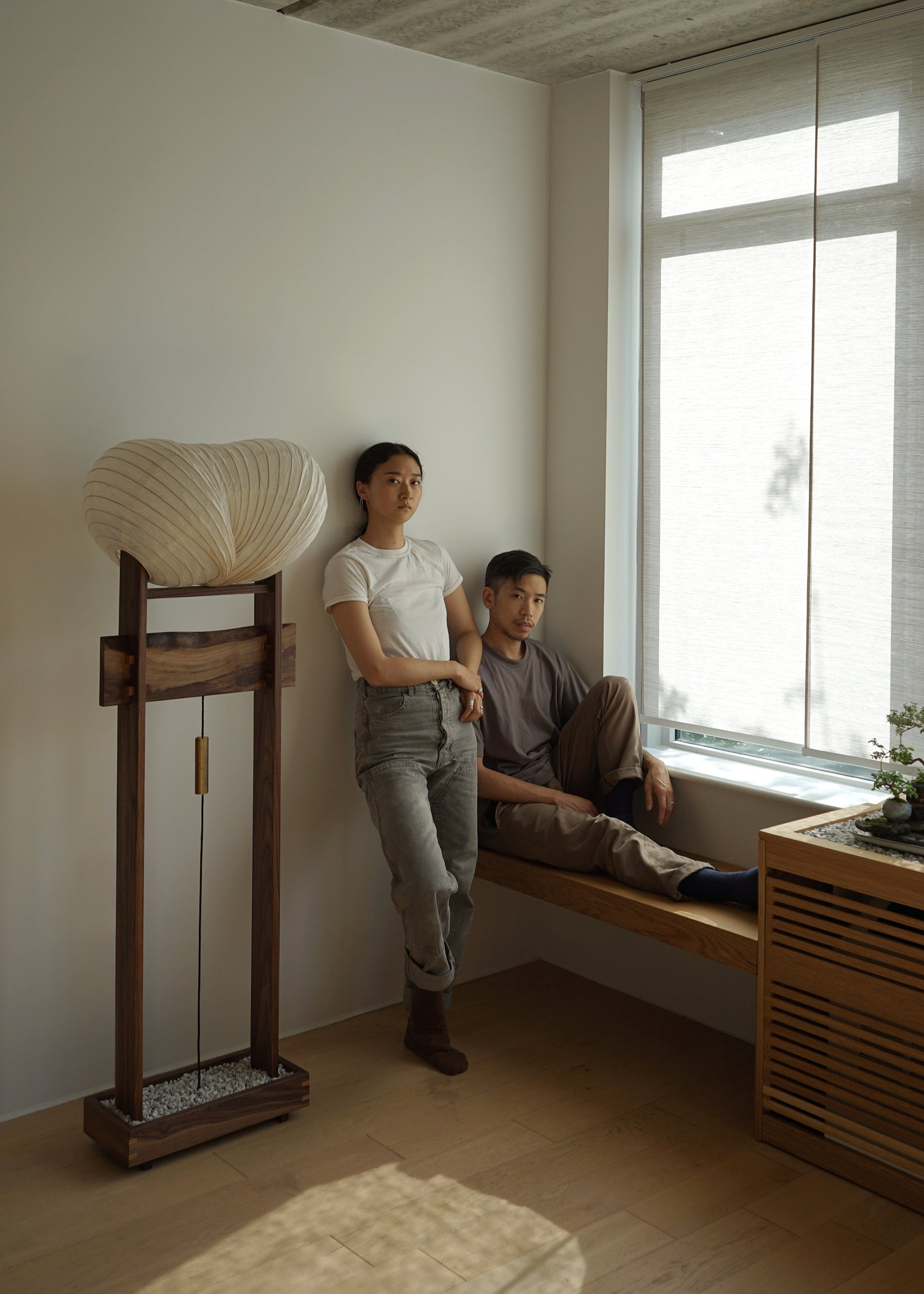 An image of Irisa and Aaron Kawabi, founders of Kawabi, beside their Souvenir Floor Lamp prototype.