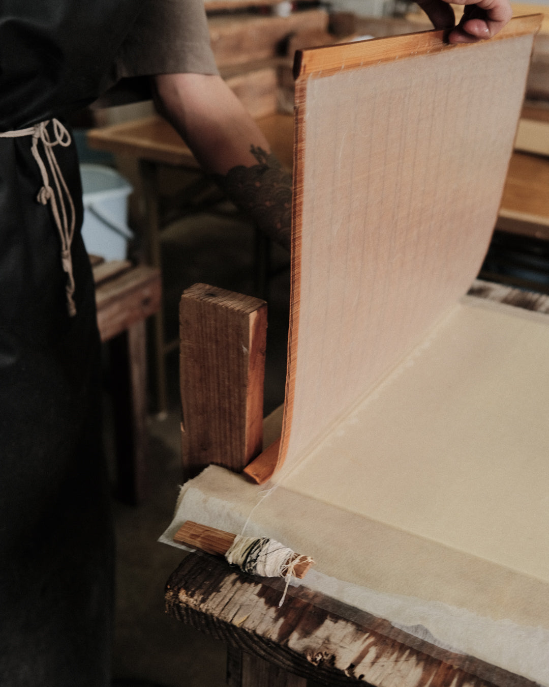 An image of Aaron Kawabi in the process of making Japanese washi by hand